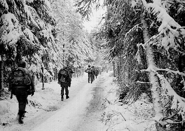 soldiers marching in the snow in the Hurtgen forest